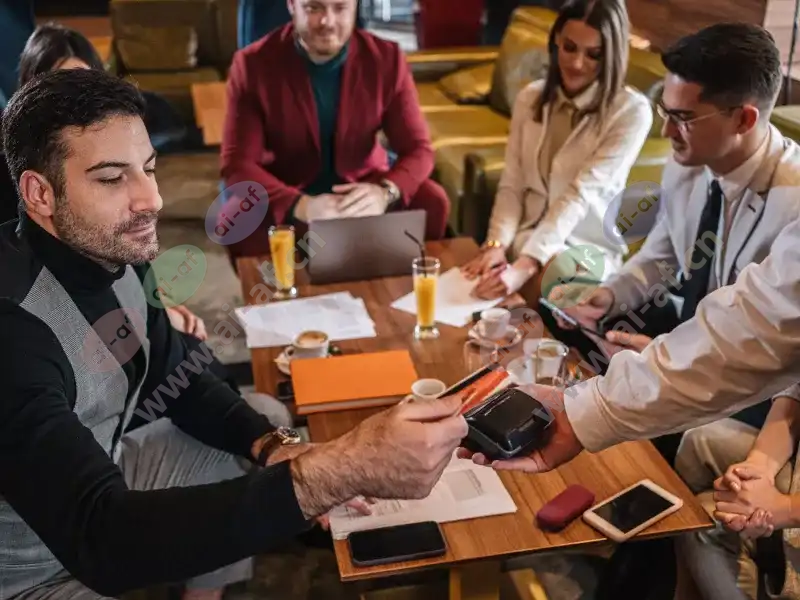 man_paying_card_reader_fika_cafe_meeting_group_2007_2600x1950.jpg.webp
