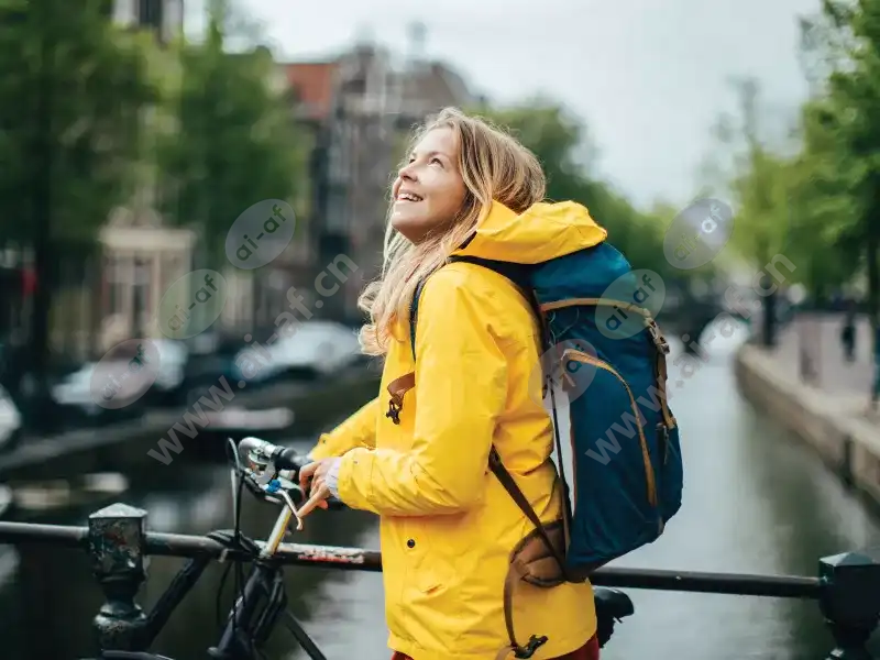 woman_bicycle_raincoat_backpack_smiling_closeup_canal_2005_2600x1950_0.jpg.webp