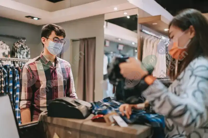 woman_cashier_helping_man_customer_clothing_store_facemasks_2104_2600x1732.jpg.webp